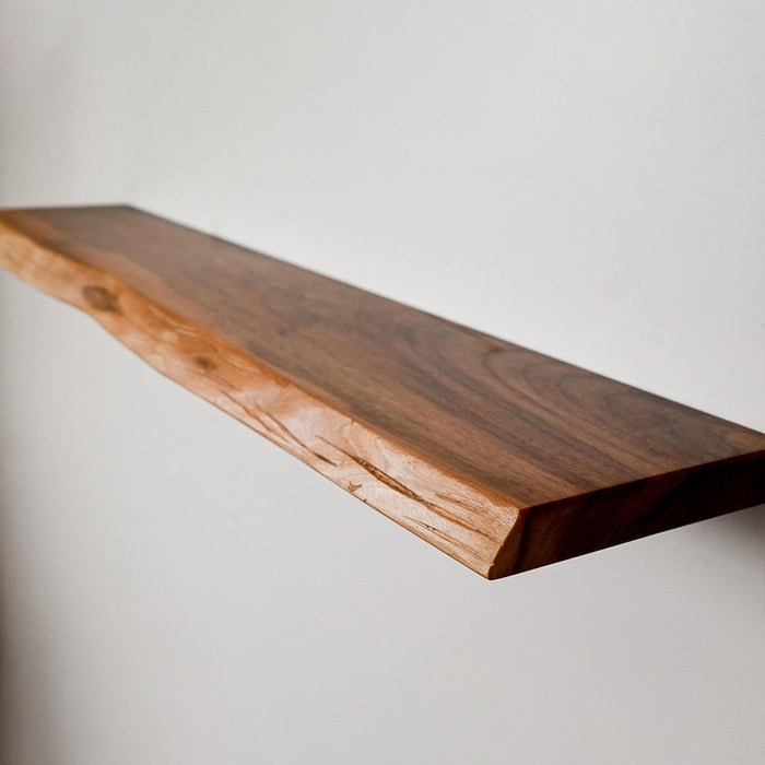 Wooden shelf against a plain wall