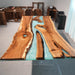 Black walnut teal epoxy dining table styled in a modern American dining room