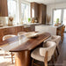 Modern kitchen dining space featuring a walnut epoxy table as the centerpiece