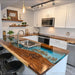 Front view of walnut blue epoxy river kitchen island countertop with live edge design and natural stone accents