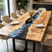 Poplar wood dining table with blue wave epoxy resin river, paired with beige leather dining chairs.