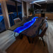 Modern black walnut epoxy resin table with deep blue LED-lit river