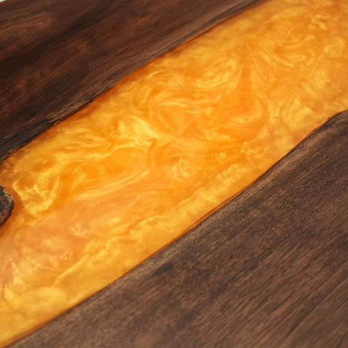 Modern walnut dining table with illuminated epoxy resin center.