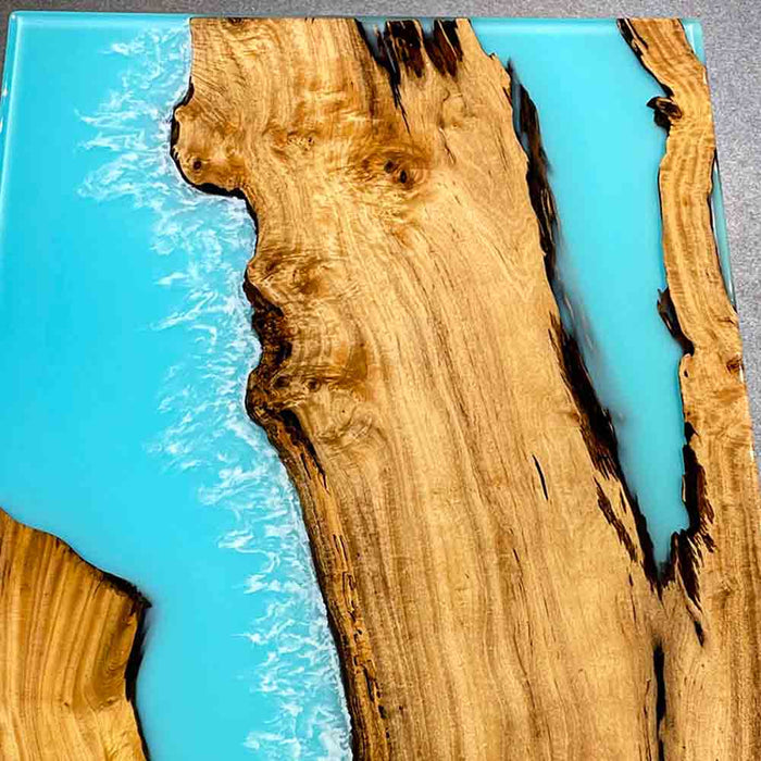 Top view showcasing the light blue epoxy resin surface and golden camphor wood patterns.