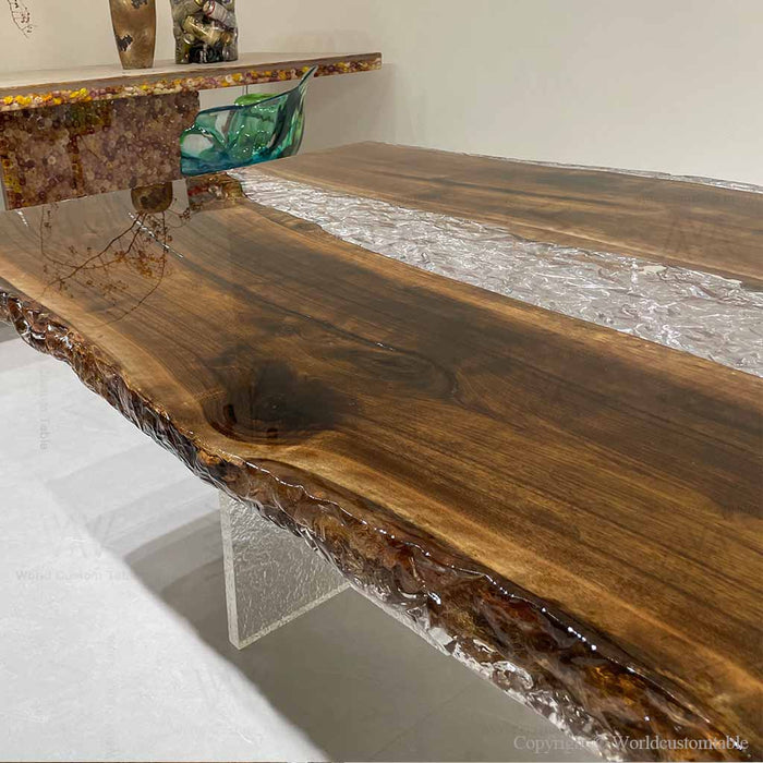 Modern dining room featuring a large wood and resin river table with industrial metal legs.