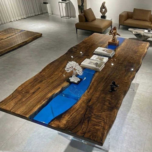 Contemporary living room table featuring a deep blue epoxy resin river and live edge walnut wood slabs.