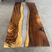 Wooden table with a natural grain pattern on a concrete floor.