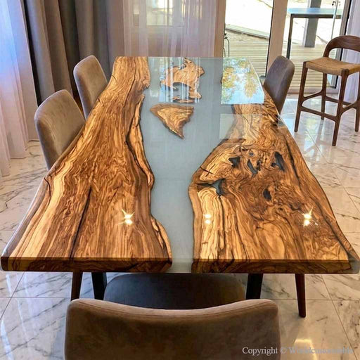 Modern dining room featuring olive wood epoxy resin table with upholstered chairs and soft lighting