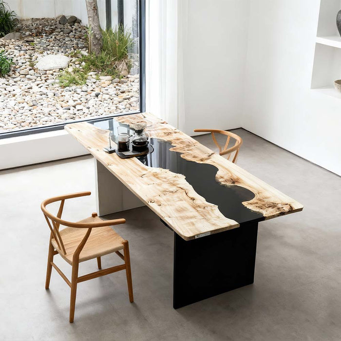 Modern dining table with black and wood design in a minimalistic room.