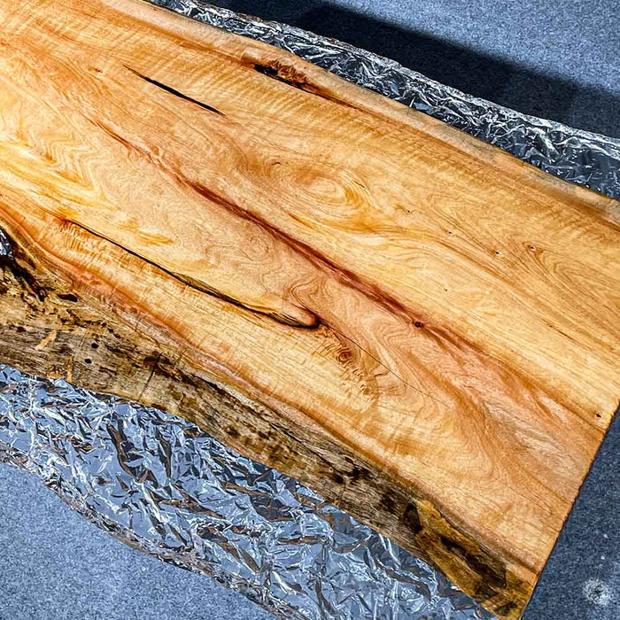 Top-down view highlighting the transparent epoxy resin surface and golden wood