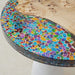 Modern resin river dining table featuring beach sand and clear epoxy