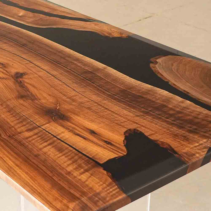 Wooden table with black resin inlay on a light background