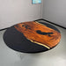 modern round walnut dining table featuring black resin