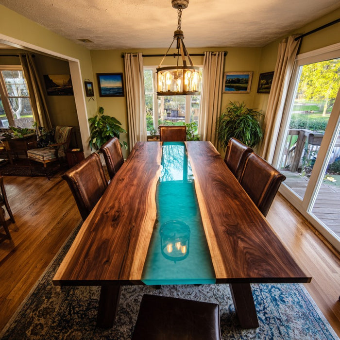 Dining room with a long wooden table featuring a blue glass inset