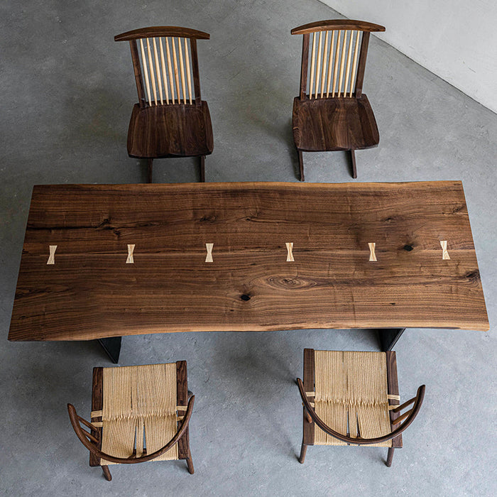 Modern solid wood conference table featuring a natural edge and butterfly inlays.