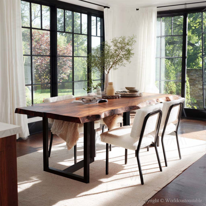 Modern dining room with a wooden table and white chairs near large windows.