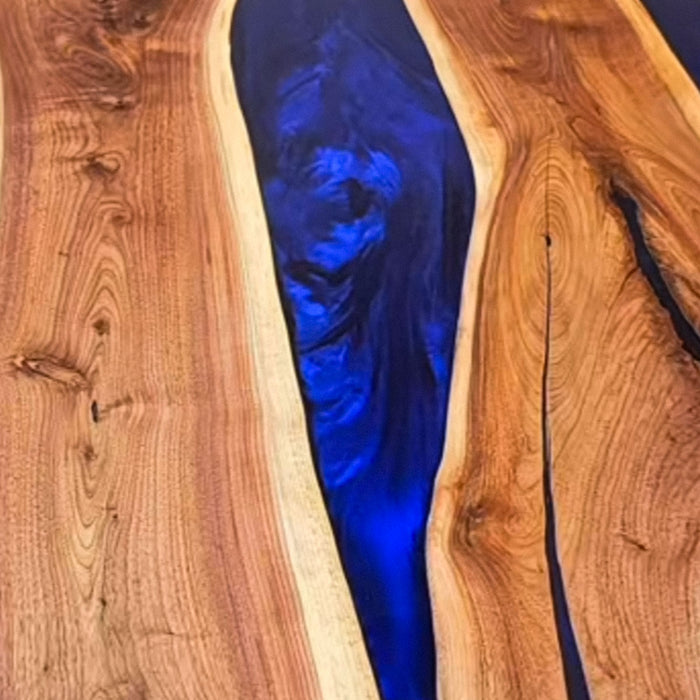 Modern walnut epoxy table featuring a deep blue resin pour