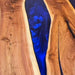 Modern walnut epoxy table featuring a deep blue resin pour