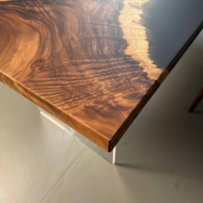 Wooden table with a dark finish on a light gray floor