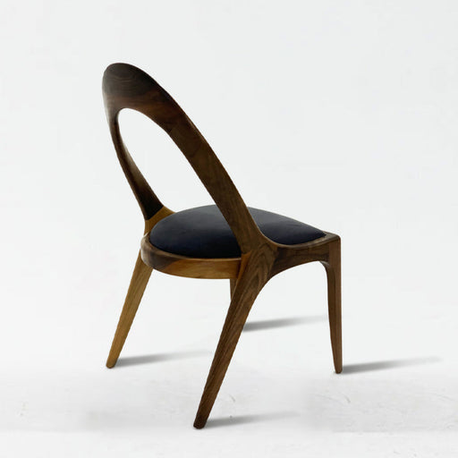 Wooden chair with black cushion on a white background