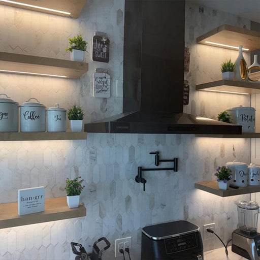 Modern kitchen interior with shelves, appliances, and decorative elements.