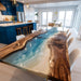 Modern kitchen with a unique wooden dining table featuring a beachscape design.
