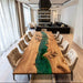Close-up of live-edge walnut wood grain and glossy green epoxy river on a handcrafted dining table.