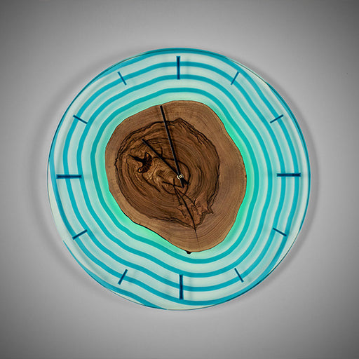 Natural wood clock featuring tree rings and blue resin ripple design