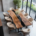 Natural walnut slab dining table with resin detail placed in a bright modern dining area.