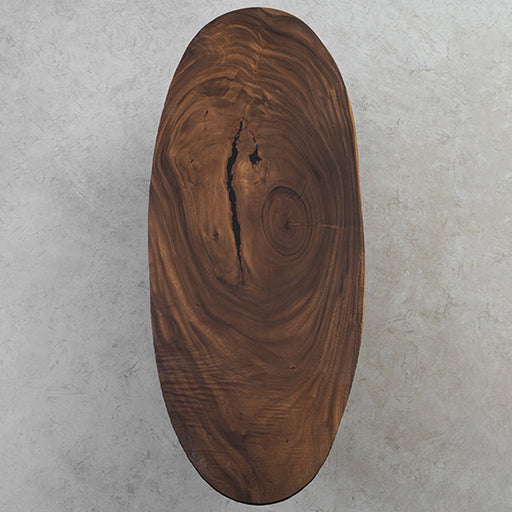 Natural walnut wood elliptical dining table made from solid slabs with smooth finish.