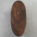 Natural walnut wood elliptical dining table made from solid slabs with smooth finish.