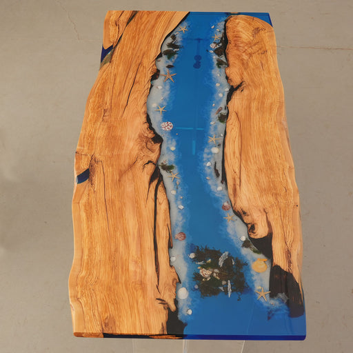 Coastal live edge olive wood table featuring vibrant ocean resin for beach house interiors
