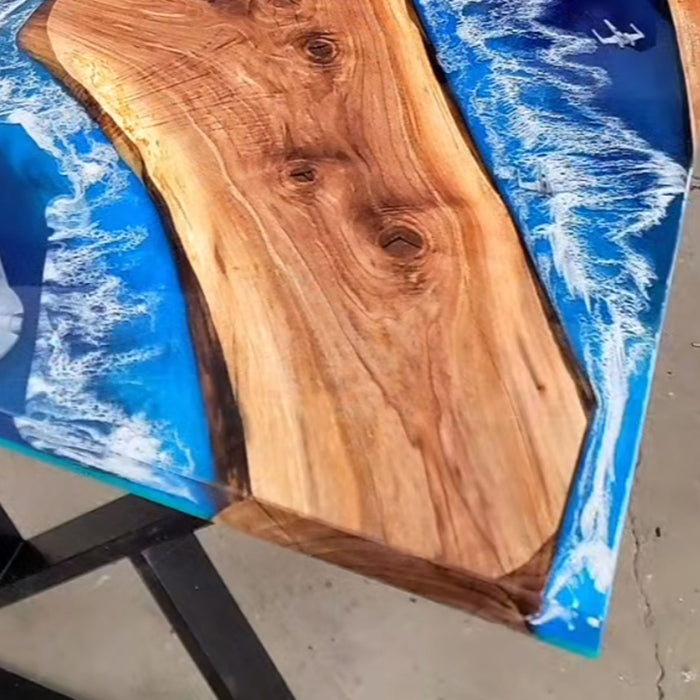 Ocean-themed epoxy river table with flowing water design in walnut wood