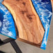 Ocean-themed epoxy river table with flowing water design in walnut wood