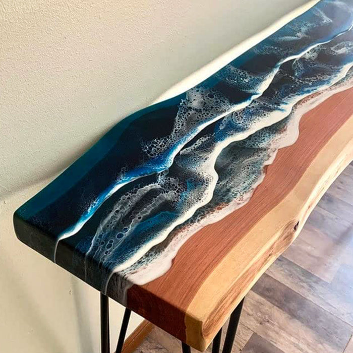 Wooden table with blue and white resin design on a neutral background