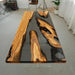 Elegant olive wood and black resin table in a culinary studio setting