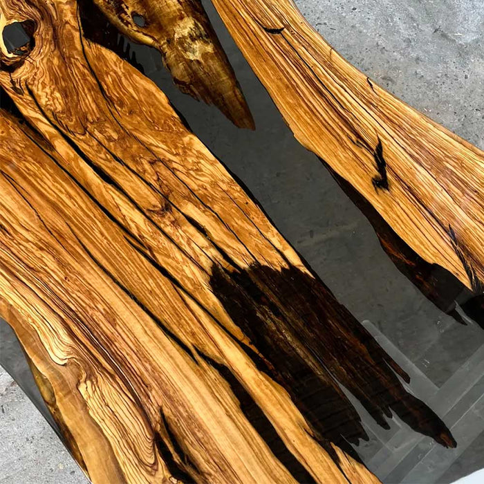 Elegant olive wood and black resin table in a culinary studio setting