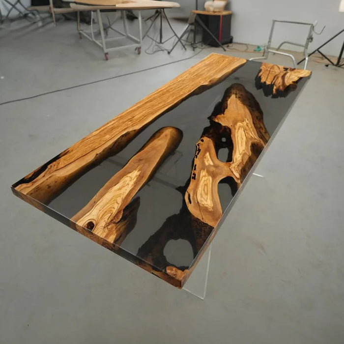 Elegant olive wood and black resin table in a culinary studio setting
