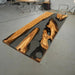 Elegant olive wood and black resin table in a culinary studio setting