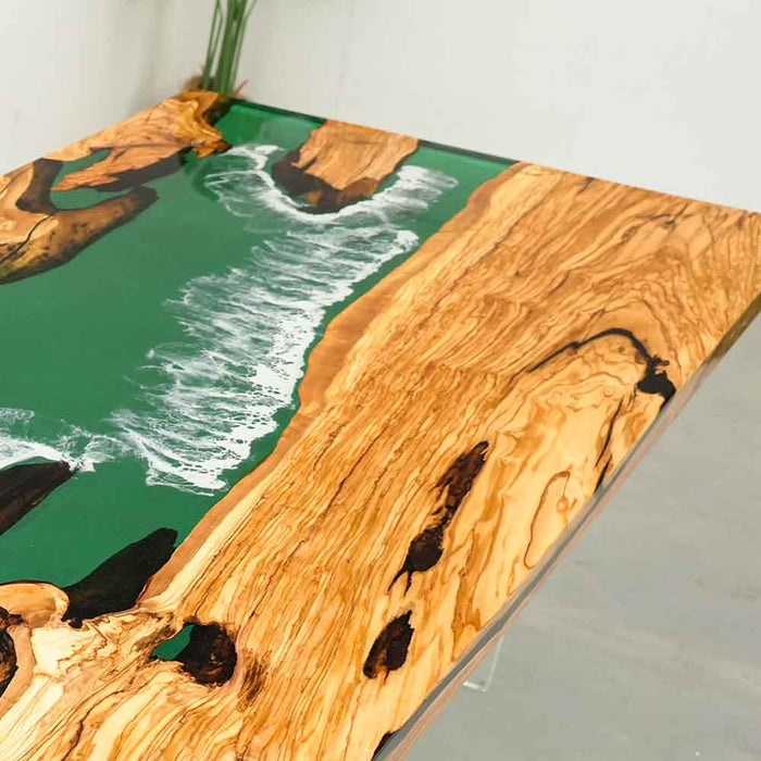 Olive semi-transparent blue wave epoxy resin table paired with modern chairs and minimalist decor.