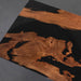 Wooden surface with black resin inlay on a dark background