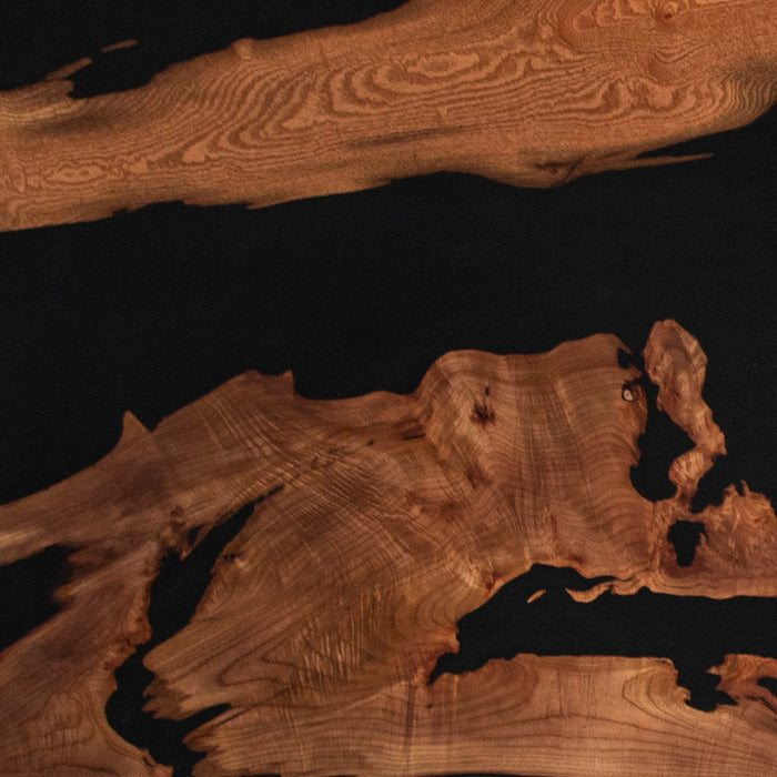 Close-up of a wooden surface with natural grain and texture on a dark background