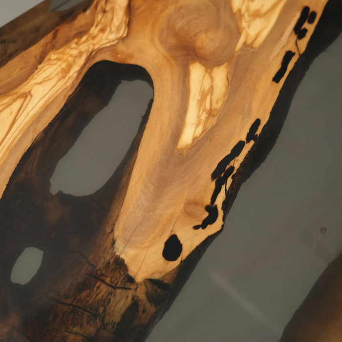 Elegant olive wood and black resin table in a culinary studio setting