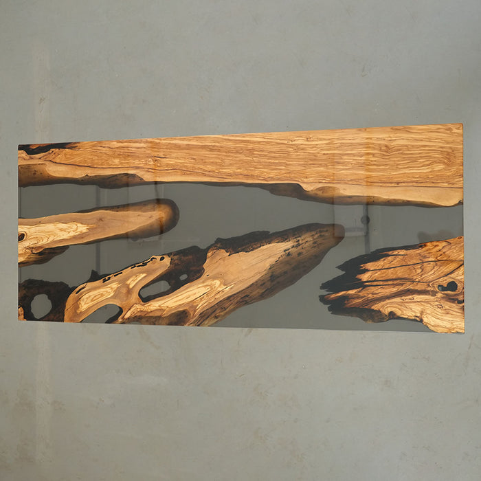 Elegant olive wood and black resin table in a culinary studio setting