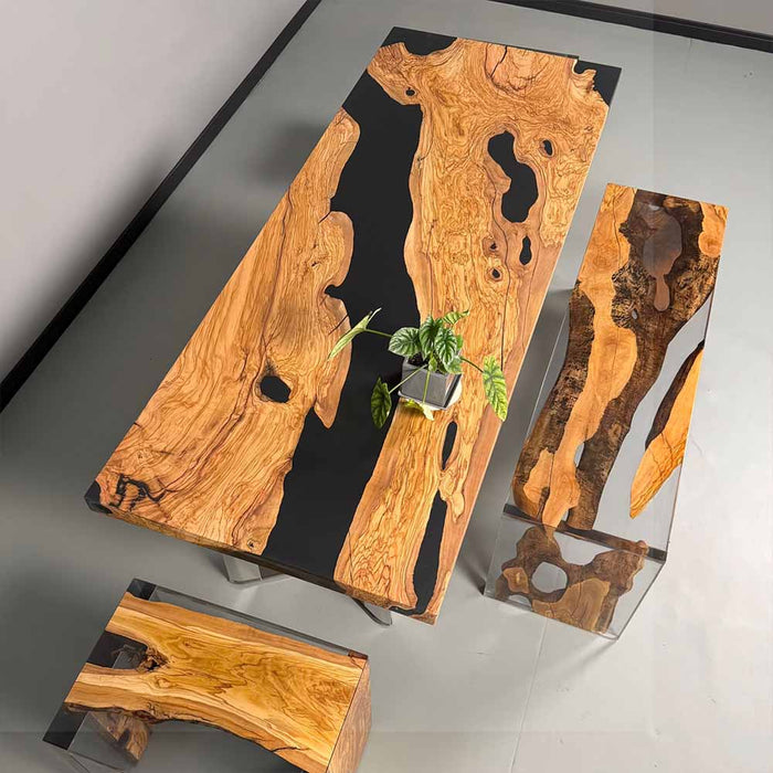 Wooden coffee table with natural grain and black resin on a gray background