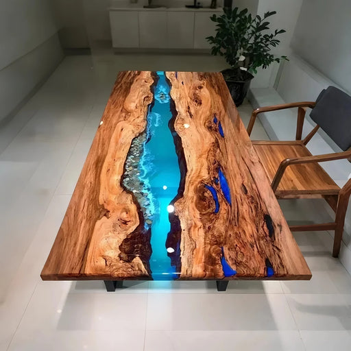 Blue epoxy river table made with natural olive wood and crystal-clear resin