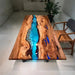Blue epoxy river table made with natural olive wood and crystal-clear resin