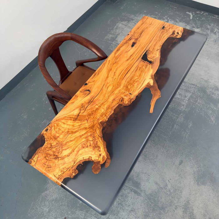 Wooden dining table with a natural finish on a gray surface