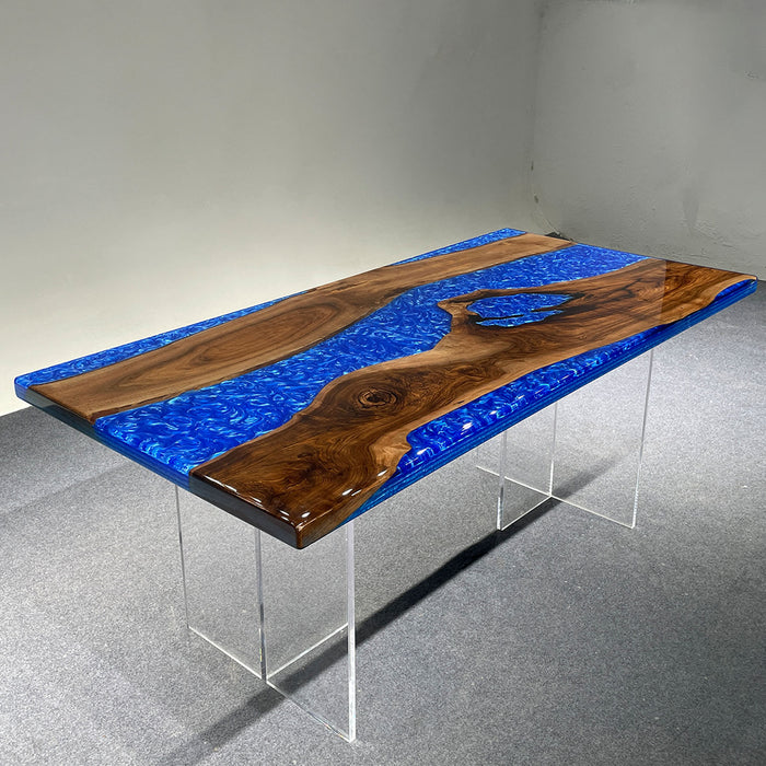 Table with blue resin and wooden design on a gray floor