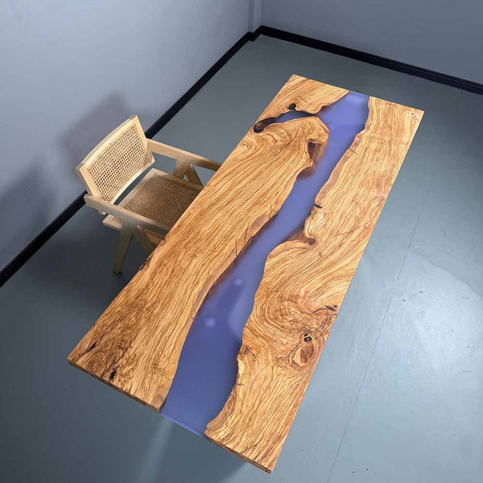 Wooden table with purple resin inlay and chair on a gray floor